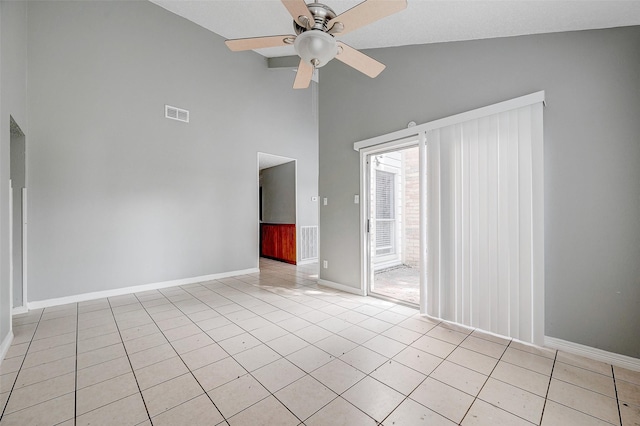 spare room featuring high vaulted ceiling, light tile patterned floors, and ceiling fan