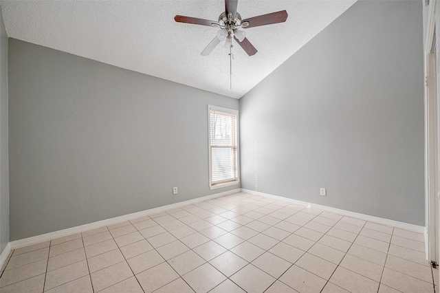 spare room featuring lofted ceiling, light tile patterned floors, a textured ceiling, and ceiling fan