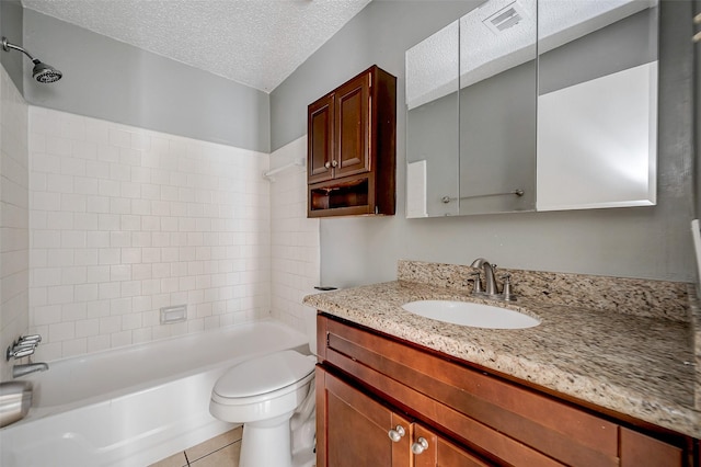 full bathroom with tiled shower / bath combo, vanity, tile patterned flooring, toilet, and a textured ceiling