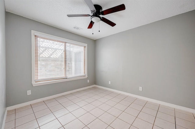 unfurnished room with ceiling fan and a textured ceiling