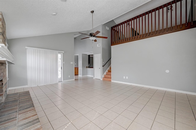 unfurnished living room with light tile patterned flooring, high vaulted ceiling, a textured ceiling, ceiling fan, and a fireplace