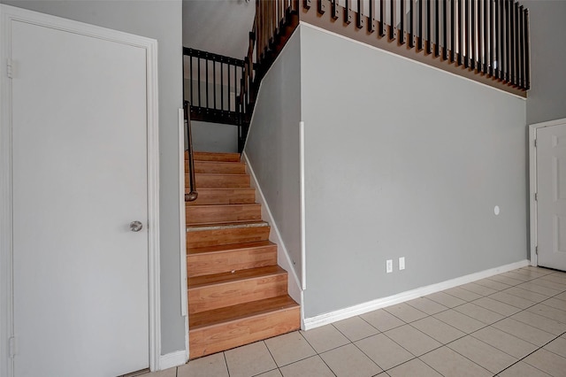 staircase with tile patterned floors