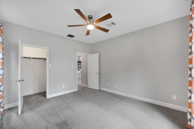 unfurnished bedroom with a closet, ceiling fan, and carpet flooring