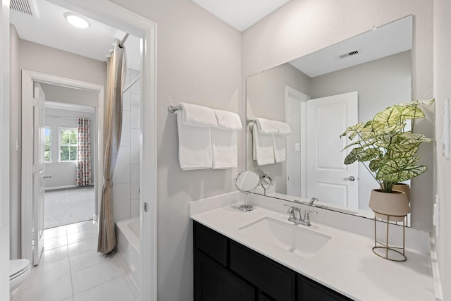 full bathroom featuring vanity, toilet, tile patterned flooring, and shower / bath combo