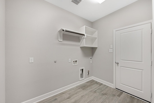 washroom featuring gas dryer hookup, light hardwood / wood-style floors, hookup for a washing machine, and electric dryer hookup