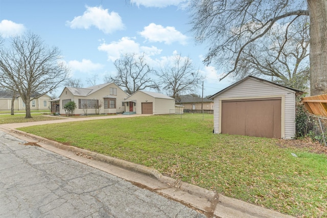 view of yard featuring a garage and an outdoor structure