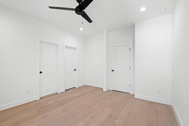 unfurnished bedroom with ceiling fan and light hardwood / wood-style flooring