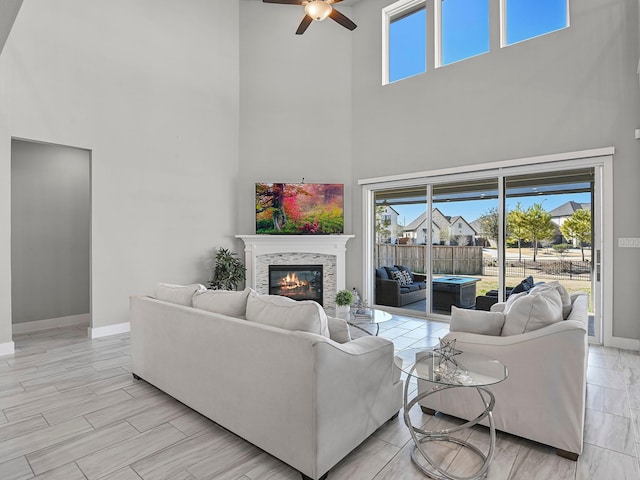 living room with ceiling fan, plenty of natural light, and light wood-type flooring