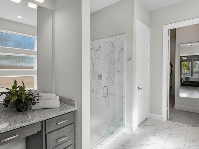 bathroom featuring vanity and a shower with shower door