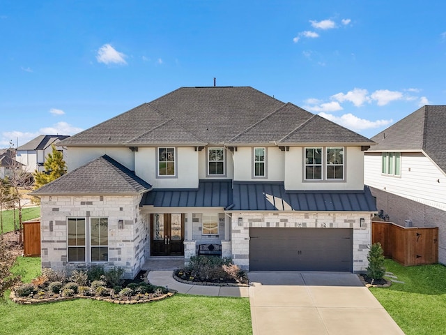 view of front of house featuring a garage and a front lawn