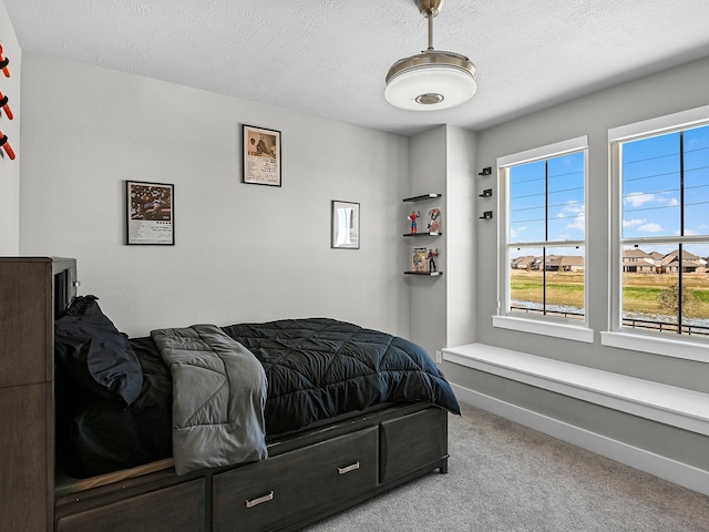 carpeted bedroom featuring a textured ceiling