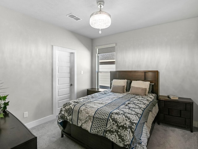 carpeted bedroom with a chandelier