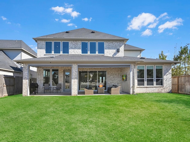 back of property with a patio and a yard