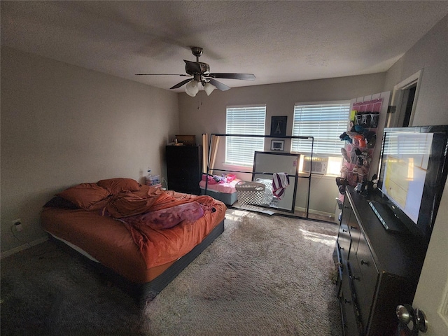 carpeted bedroom with ceiling fan and a textured ceiling