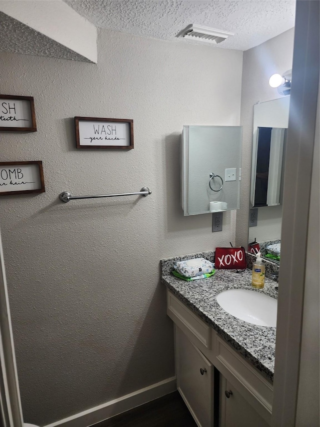 bathroom featuring vanity and a textured ceiling