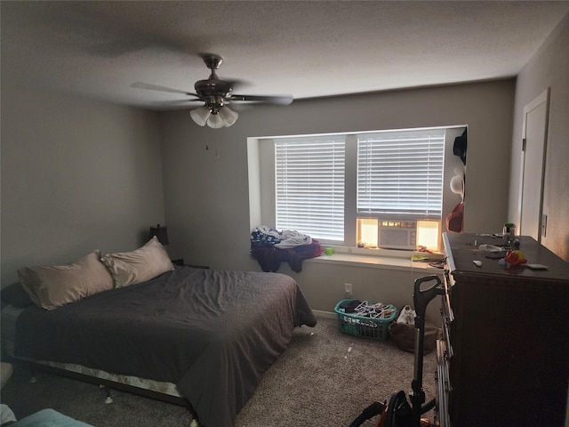 bedroom featuring cooling unit, a textured ceiling, ceiling fan, and carpet