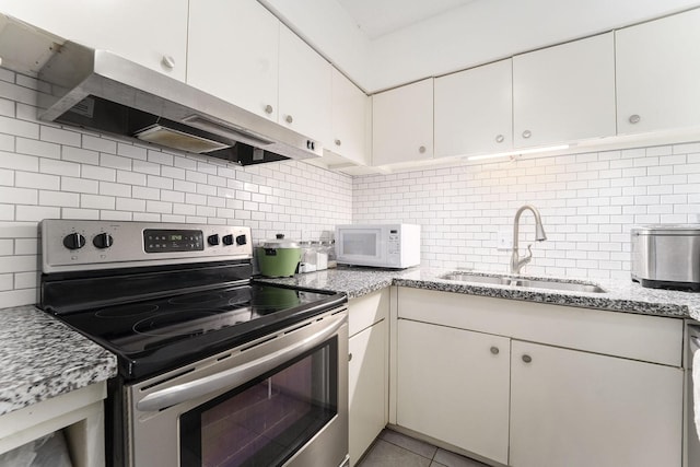 kitchen with electric stove, ventilation hood, sink, and white cabinets