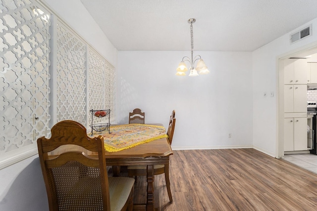 dining room featuring a chandelier and light hardwood / wood-style floors