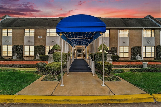 view of outdoor building at dusk