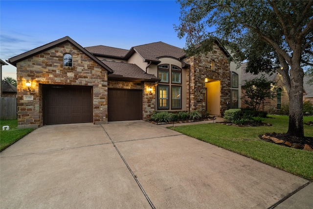 view of front of home featuring a yard and a garage