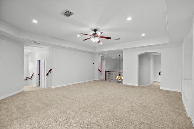 unfurnished living room featuring ceiling fan and light colored carpet