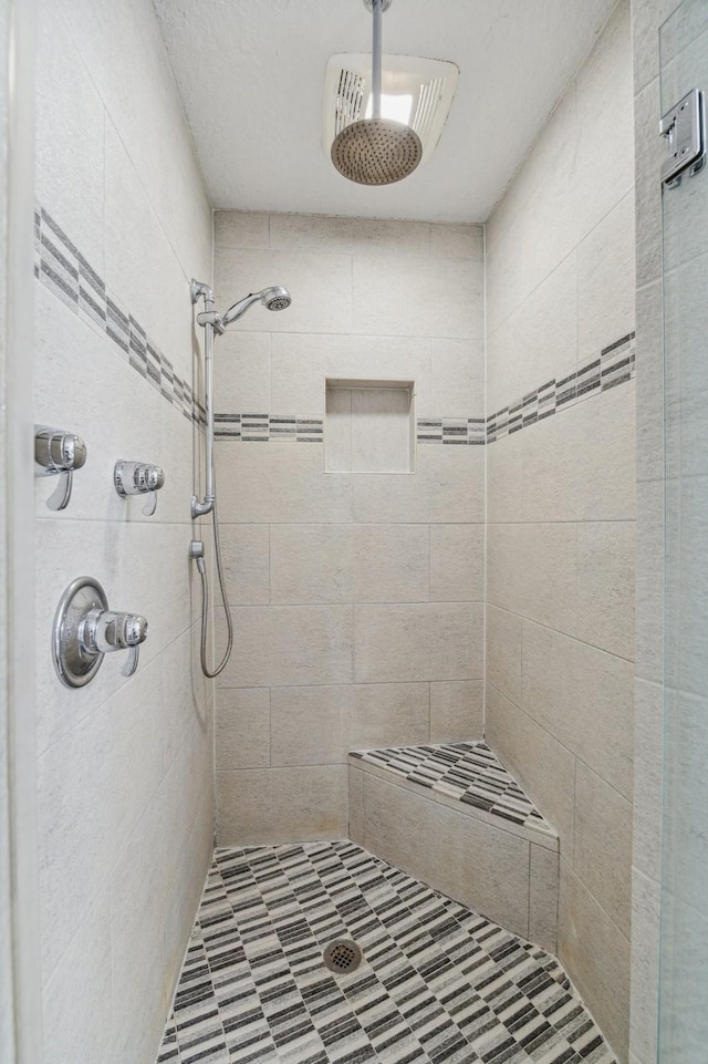 bathroom with tiled shower