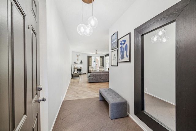 corridor featuring hardwood / wood-style floors and a notable chandelier