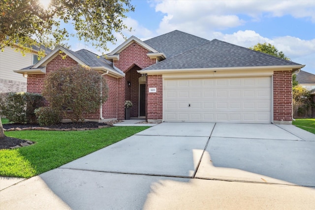 view of front of property featuring a garage and a front yard