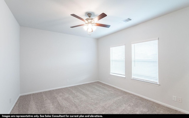 spare room featuring carpet flooring and ceiling fan