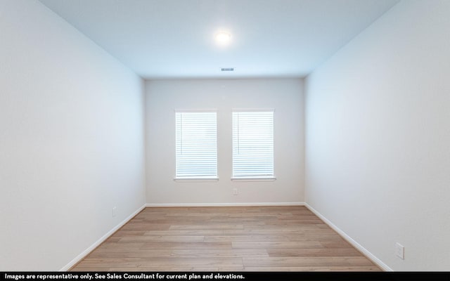 spare room featuring light wood-type flooring