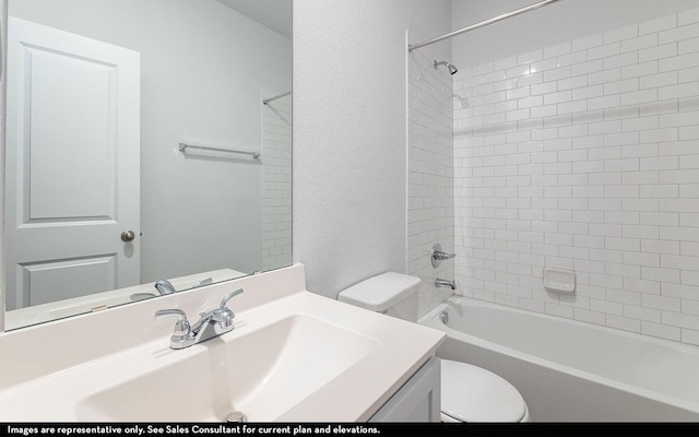 full bathroom with tiled shower / bath, vanity, and toilet