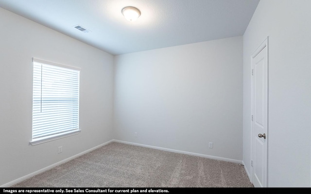 spare room with light colored carpet