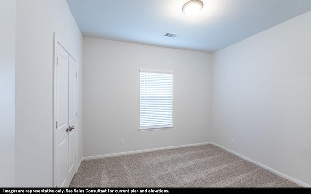 unfurnished room with light colored carpet