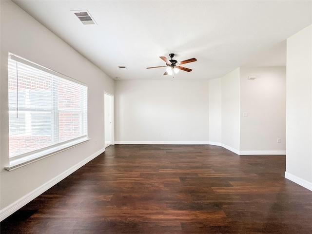 empty room with dark wood-type flooring and ceiling fan