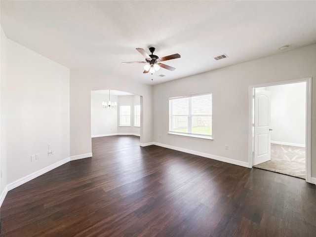 unfurnished room with dark wood-type flooring and ceiling fan with notable chandelier