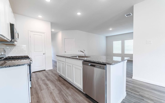 10775 Sora Dr, Willis, TX 77378 - kitchen featuring a sink, stainless steel appliances, visible vents, and light wood-style floors