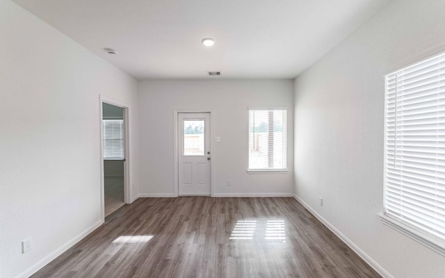 10775 Sora Dr, Willis, TX 77378 - foyer entrance featuring visible vents, wood finished floors, and baseboards