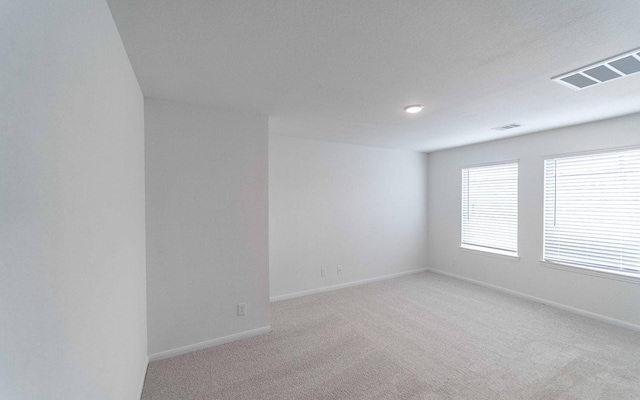 10775 Sora Dr, Willis, TX 77378 - unfurnished room featuring baseboards, visible vents, and light colored carpet