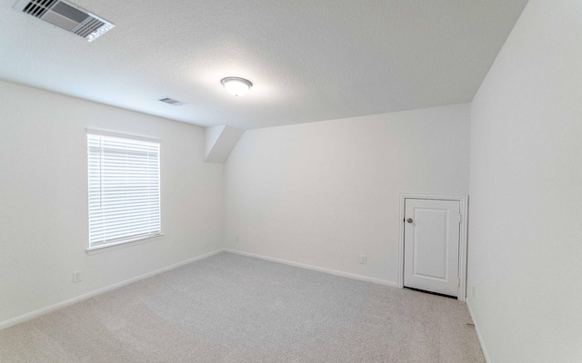 10775 Sora Dr, Willis, TX 77378 - additional living space with baseboards, visible vents, and carpet