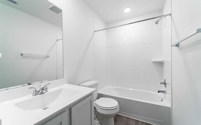 10775 Sora Dr, Willis, TX 77378 - full bath featuring toilet, wood finished floors, vanity, visible vents, and bathing tub / shower combination