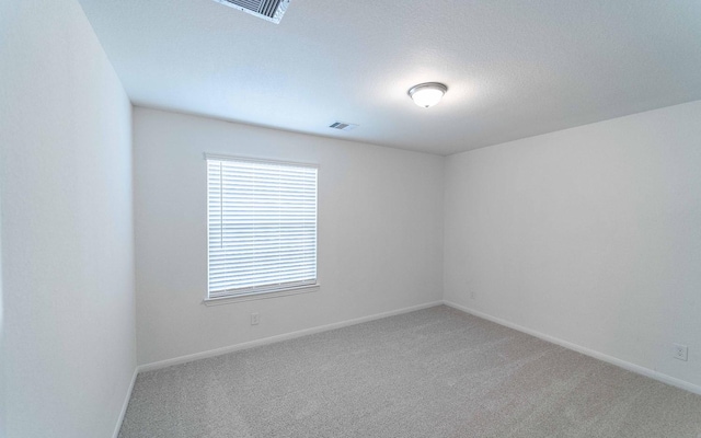 10775 Sora Dr, Willis, TX 77378 - carpeted empty room featuring visible vents and baseboards