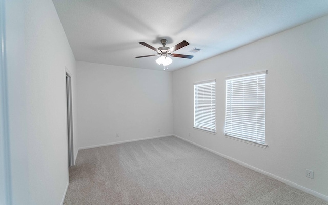 10775 Sora Dr, Willis, TX 77378 - spare room with baseboards, ceiling fan, visible vents, and light colored carpet