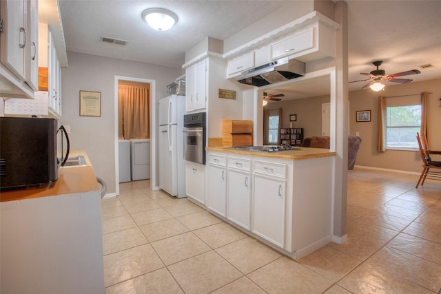 kitchen featuring white cabinetry, ceiling fan, washing machine and clothes dryer, and appliances with stainless steel finishes