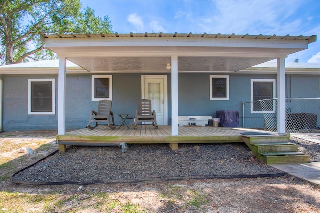 81 Fm 3454th Rd, Huntsville, TX 77320 - back of house with stucco siding and a metal roof