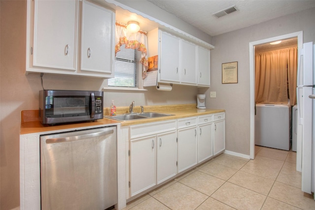 kitchen with white cabinetry, sink, light tile patterned floors, and stainless steel appliances