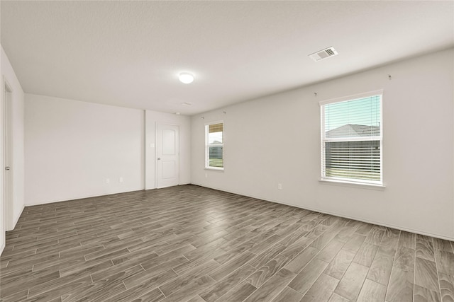 unfurnished room featuring visible vents and wood finished floors