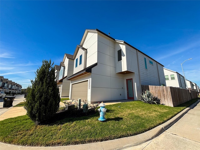 view of front facade with a garage and a front lawn