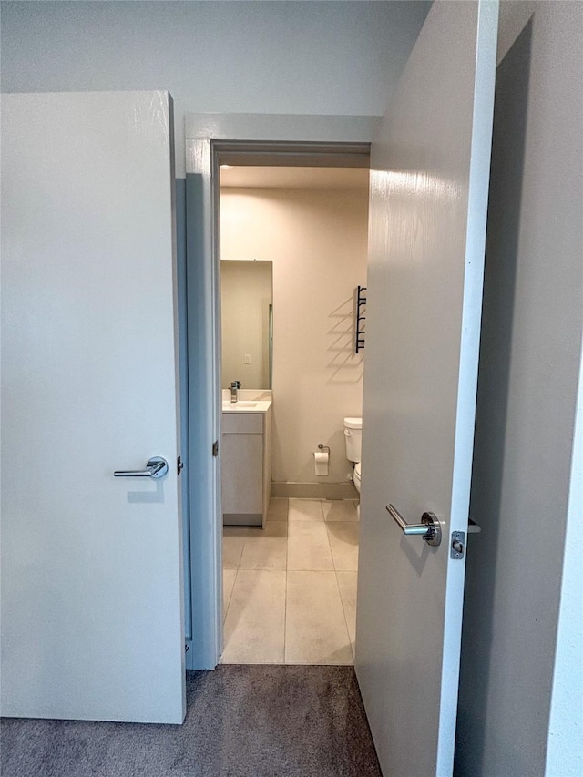 bathroom featuring vanity, tile patterned floors, and toilet