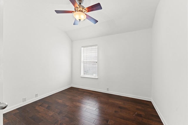 empty room with dark wood-type flooring, ceiling fan, and vaulted ceiling