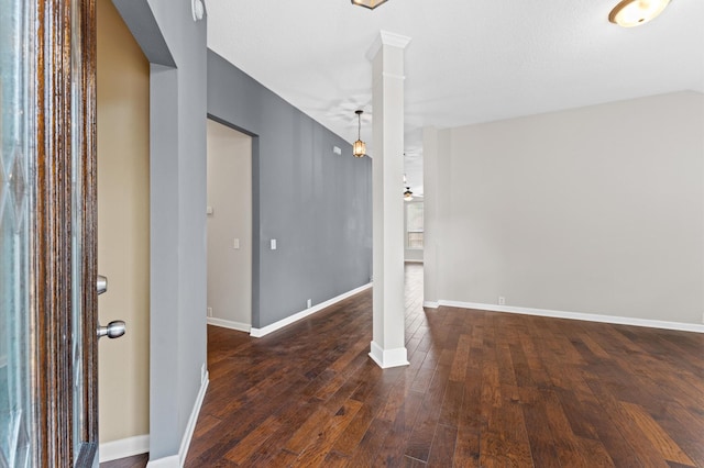 interior space featuring dark hardwood / wood-style flooring and ornate columns